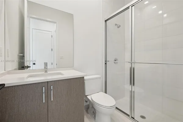 a bathroom with a sink toilet and shower