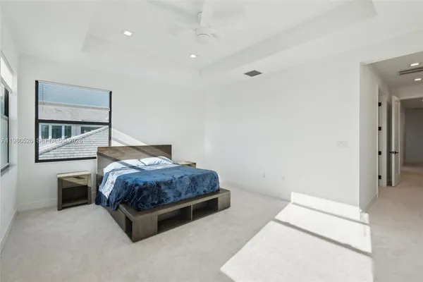 a living room with a bed and a dresser