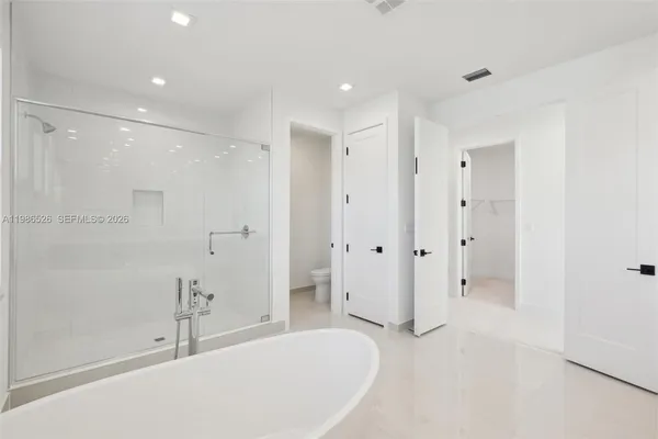 a bathroom with a bathtub and a shower