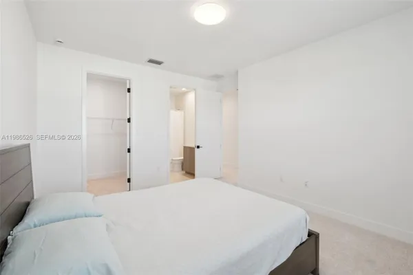 a bedroom with a bed and a lamp