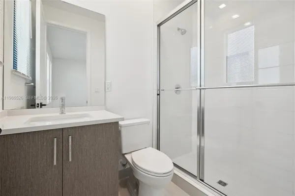 a bathroom with a sink toilet and shower