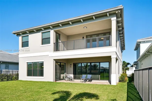 front view of a house with a yard balcony and seating area