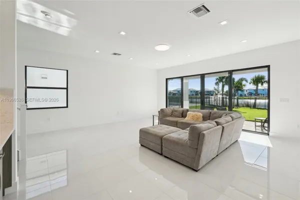 a living room with furniture and a large window
