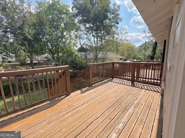 a view of deck with wooden floor and fence