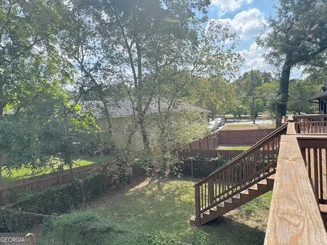 a view of a balcony with wooden fence and floor