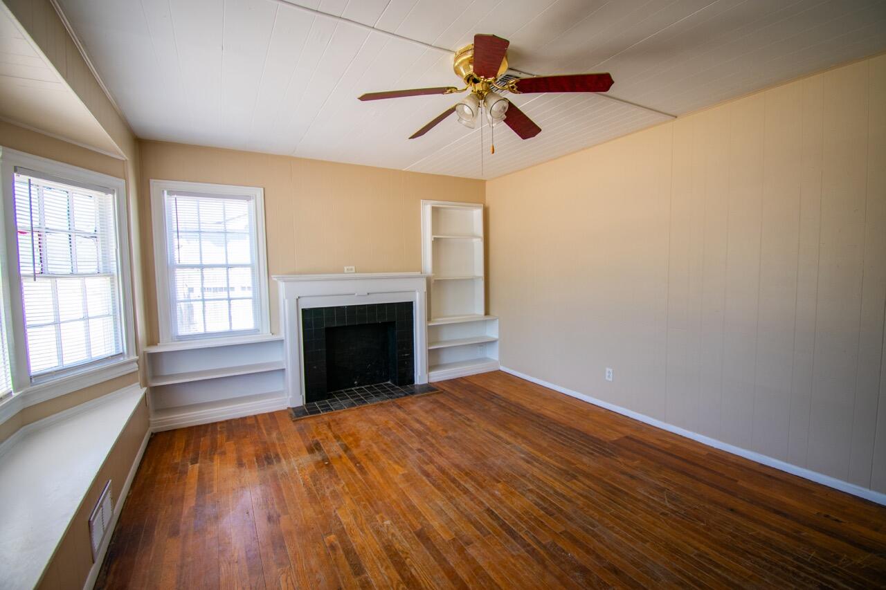 2424 27th Street Lubbock, TX 79411 - Photo 3 of 14 wooden floor in an empty room with a window