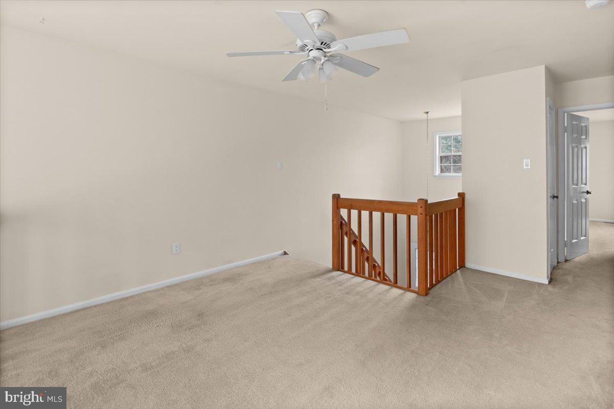 36 Needham Way Princeton, NJ 08540 - Photo 13 of 27 an empty room with a ceiling fan and a window