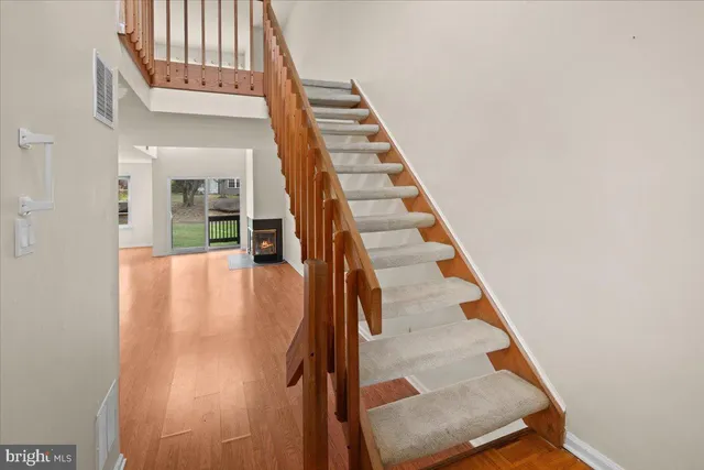 a view of entryway and hall with wooden floor