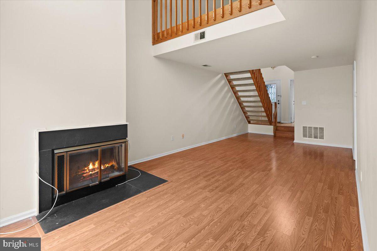 36 Needham Way Princeton, NJ 08540 - Photo 6 of 27 a view of an empty room with wooden floor fireplace and a window