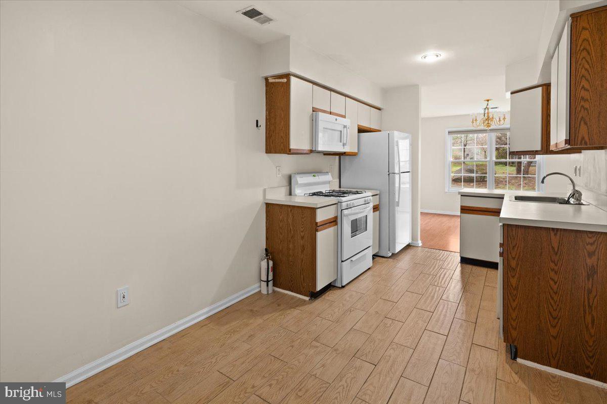 36 Needham Way Princeton, NJ 08540 - Photo 9 of 27 a kitchen with stainless steel appliances granite countertop a sink stove and cabinets
