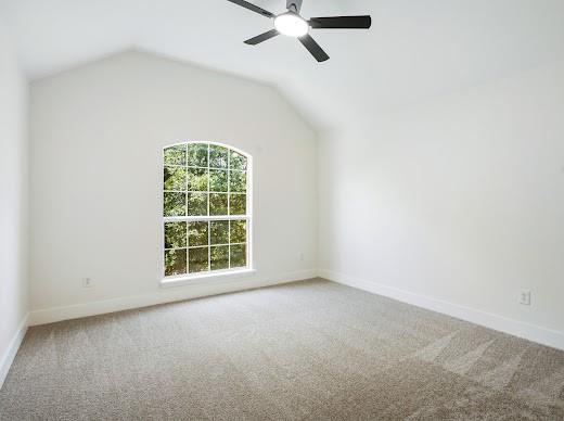 5034 West Fall Drive Midlothian, TX 76065 - Photo 25 of 40 Room featuring a vaulted ceiling with a ceiling fan, arched window, and neutral carpet flooring