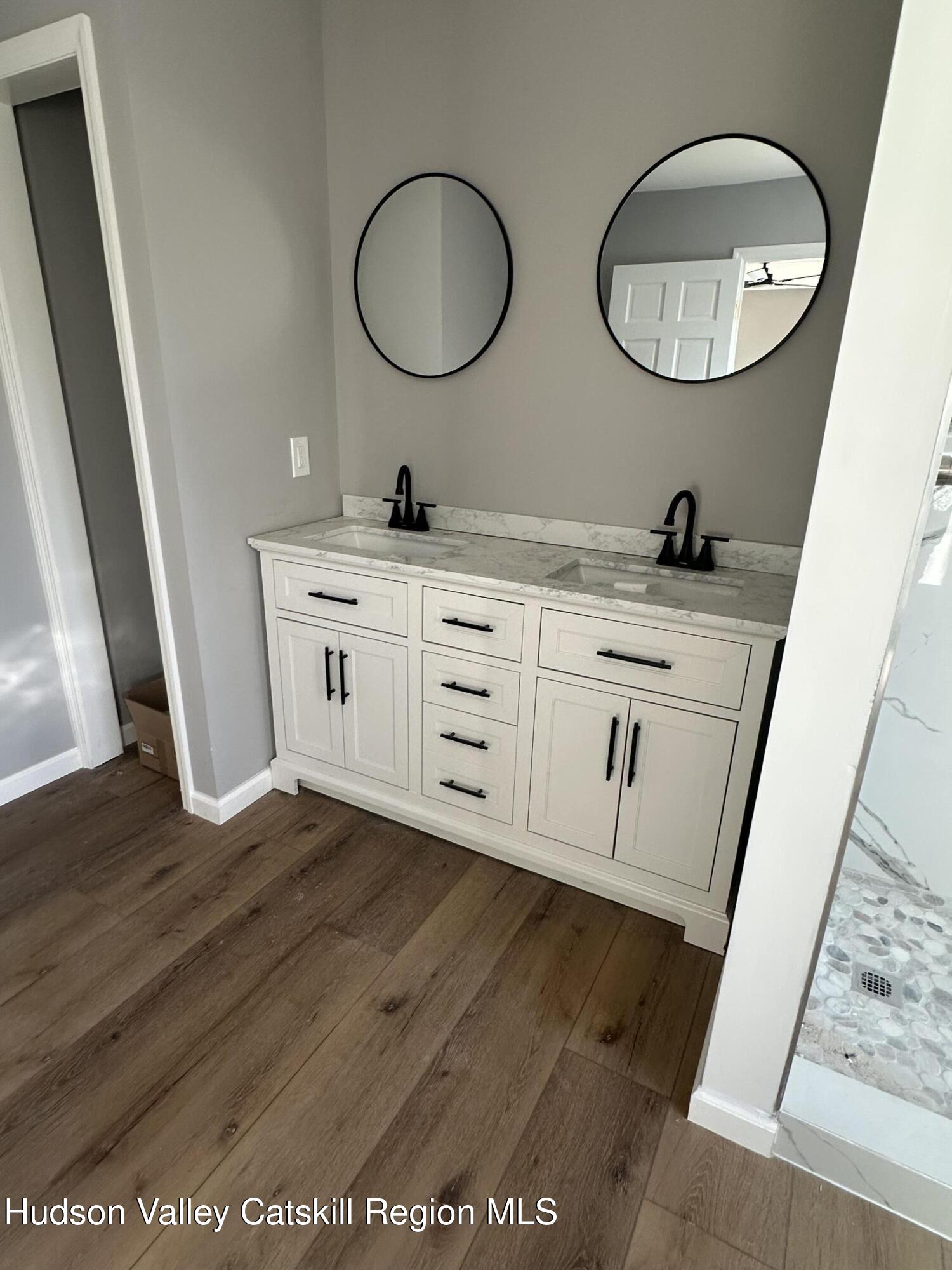 35 Olivers Way Cairo, NY 12413 - Photo 20 of 22 a bathroom with a double vanity sink and a mirror