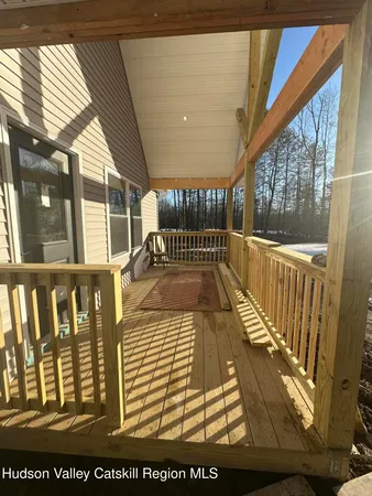 a view of a porch with wooden floor