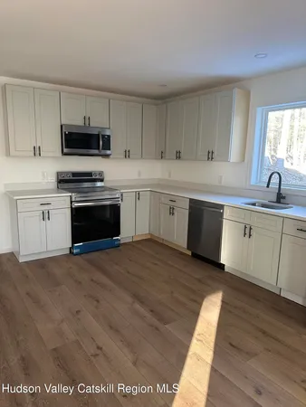 a kitchen with stainless steel appliances granite countertop a stove sink and cabinets