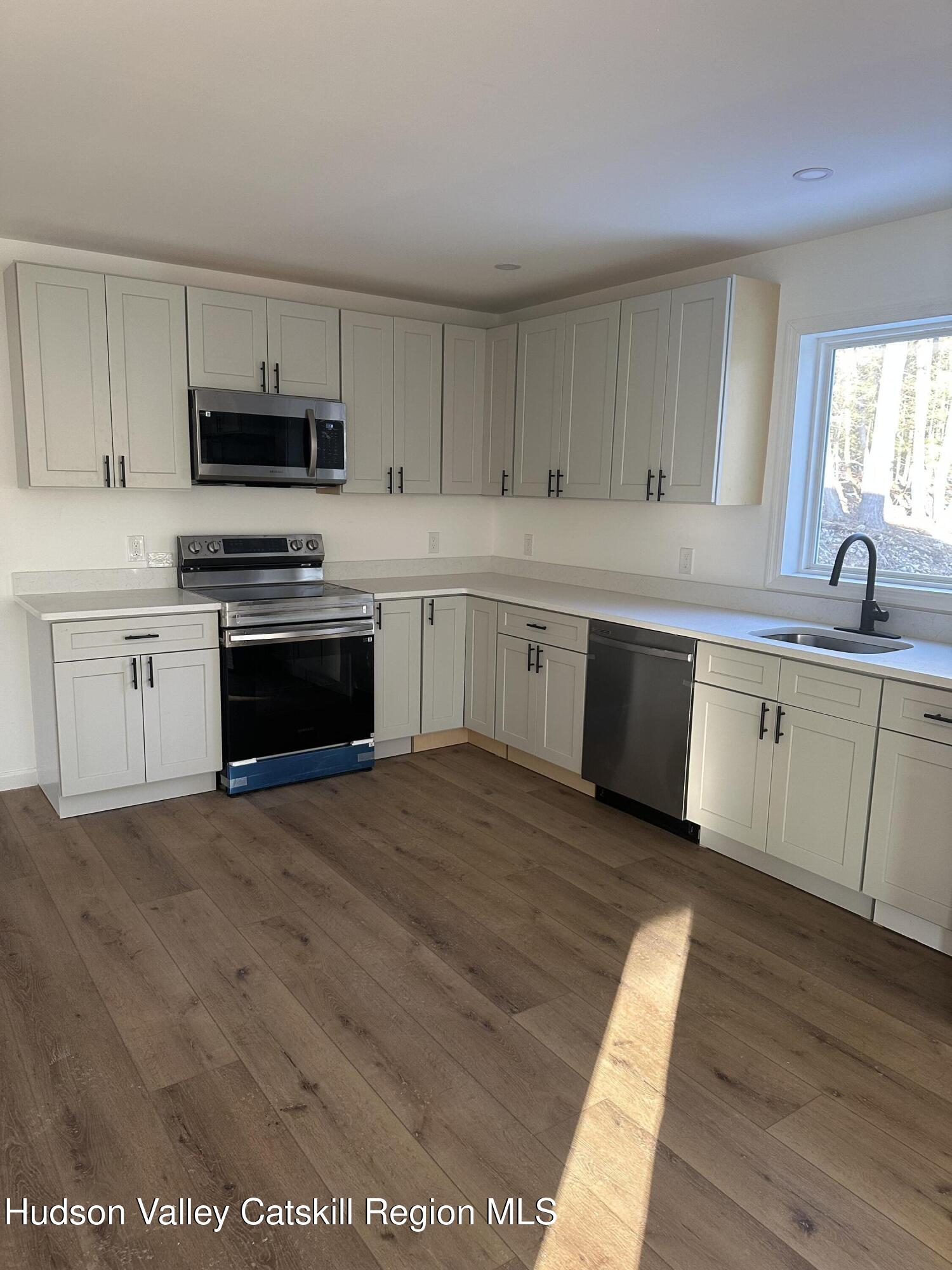 35 Olivers Way Cairo, NY 12413 - Photo 7 of 22 a kitchen with stainless steel appliances granite countertop a stove sink and cabinets