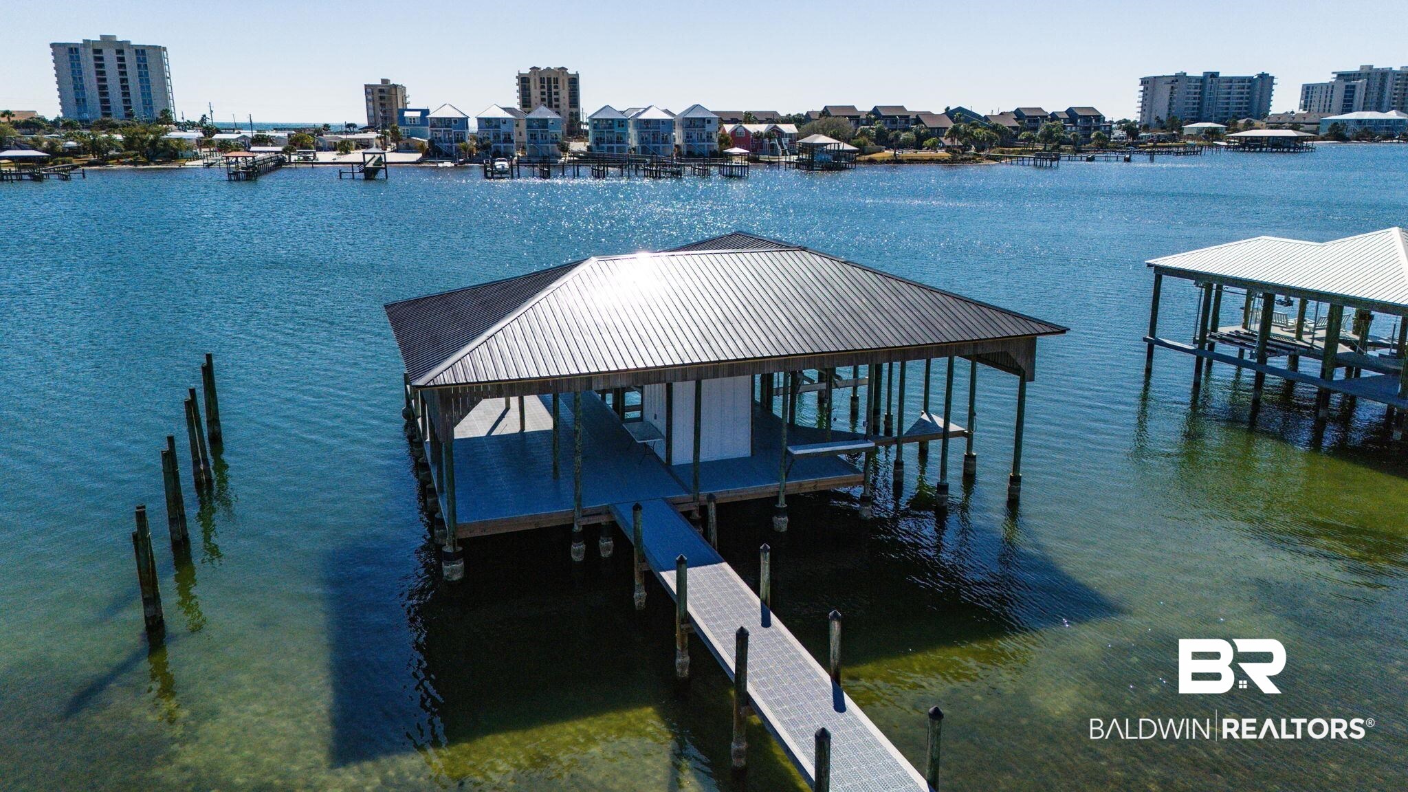 30194 River Road Orange Beach, AL 36561 - Photo 35 of 45 Dock with boat lift and a water view