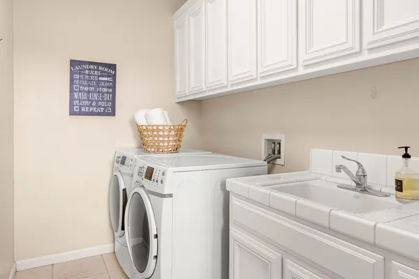 a kitchen with granite countertop a stove a sink a window and dining table