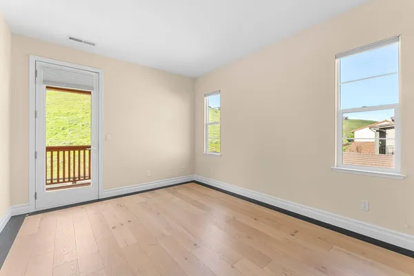 a view of a city from a balcony with furniture