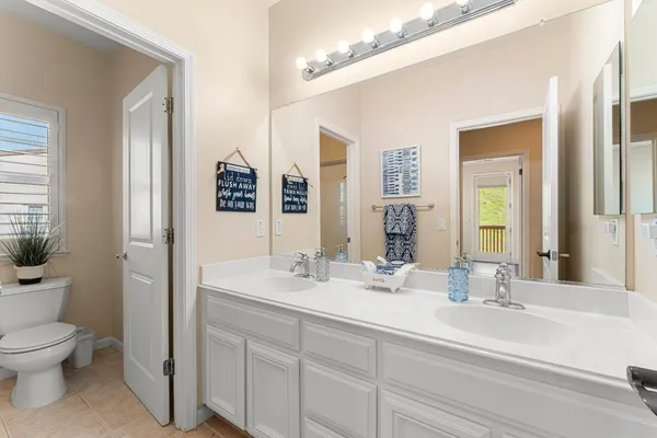 a bathroom with a double vanity sink mirror and bathtub