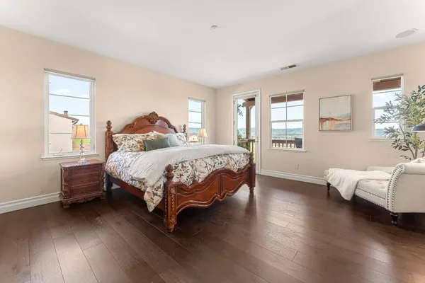 a spacious bathroom with a tub sink and mirror