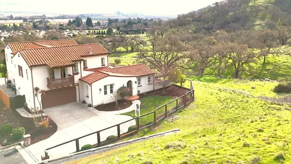 an aerial view of a residential houses with outdoor space