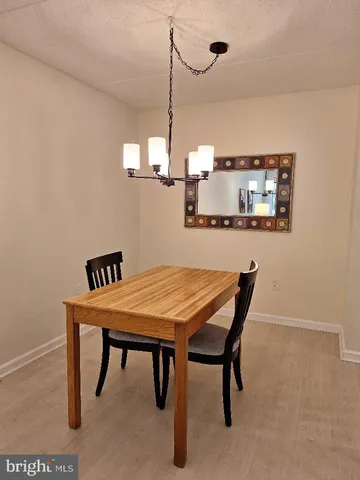 a dining room with a table and chairs