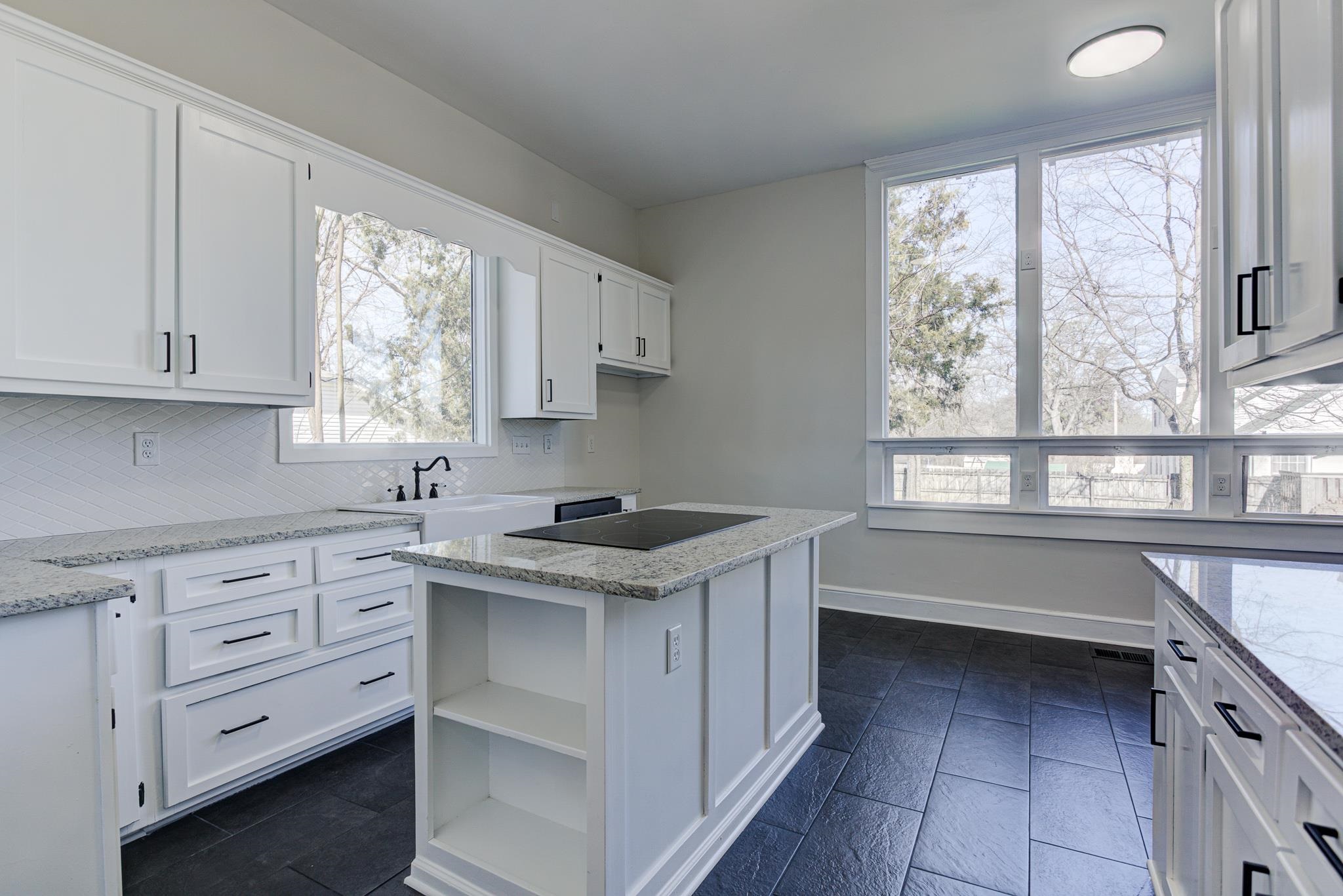 843 South Main Street Covington, TN 38019 - Photo 11 of 25 a kitchen with a stove a sink and a window
