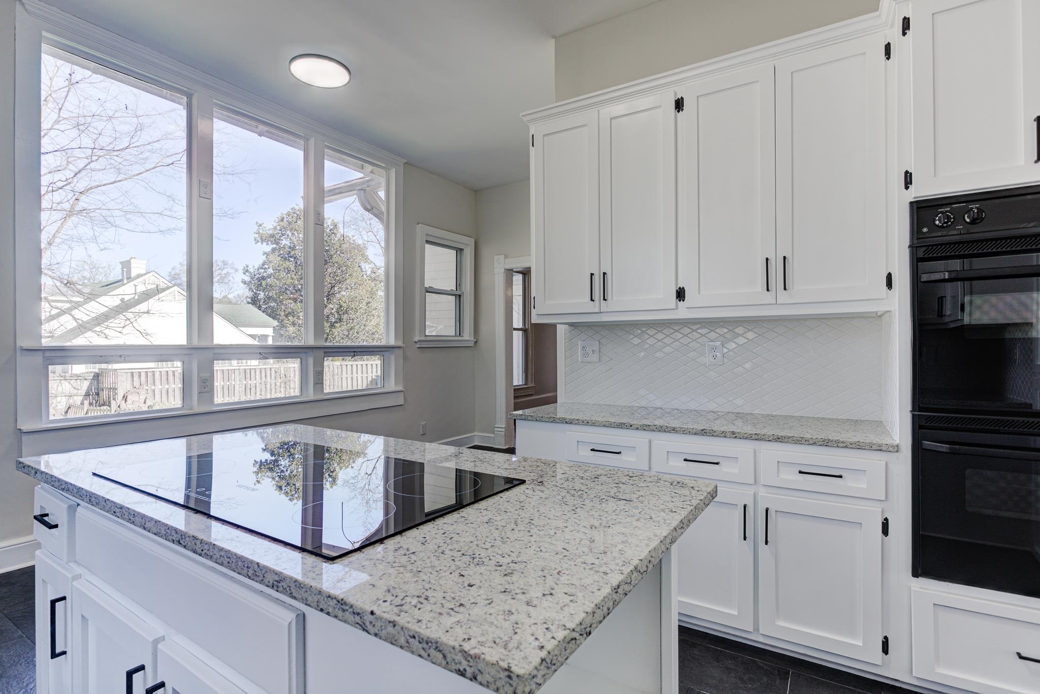 843 South Main Street Covington, TN 38019 - Photo 12 of 25 a kitchen with granite countertop white cabinets and a window