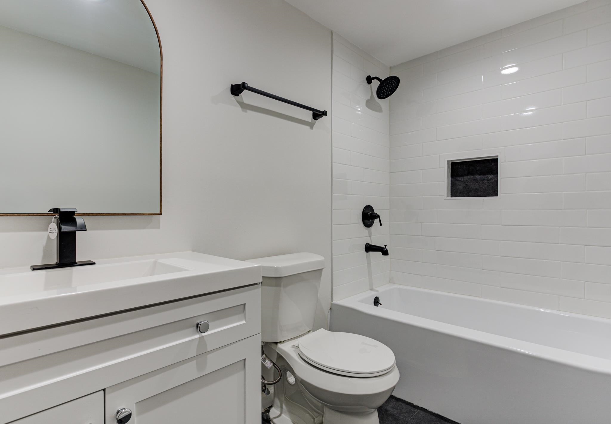 843 South Main Street Covington, TN 38019 - Photo 21 of 25 a bathroom with a sink a toilet and a bathtub