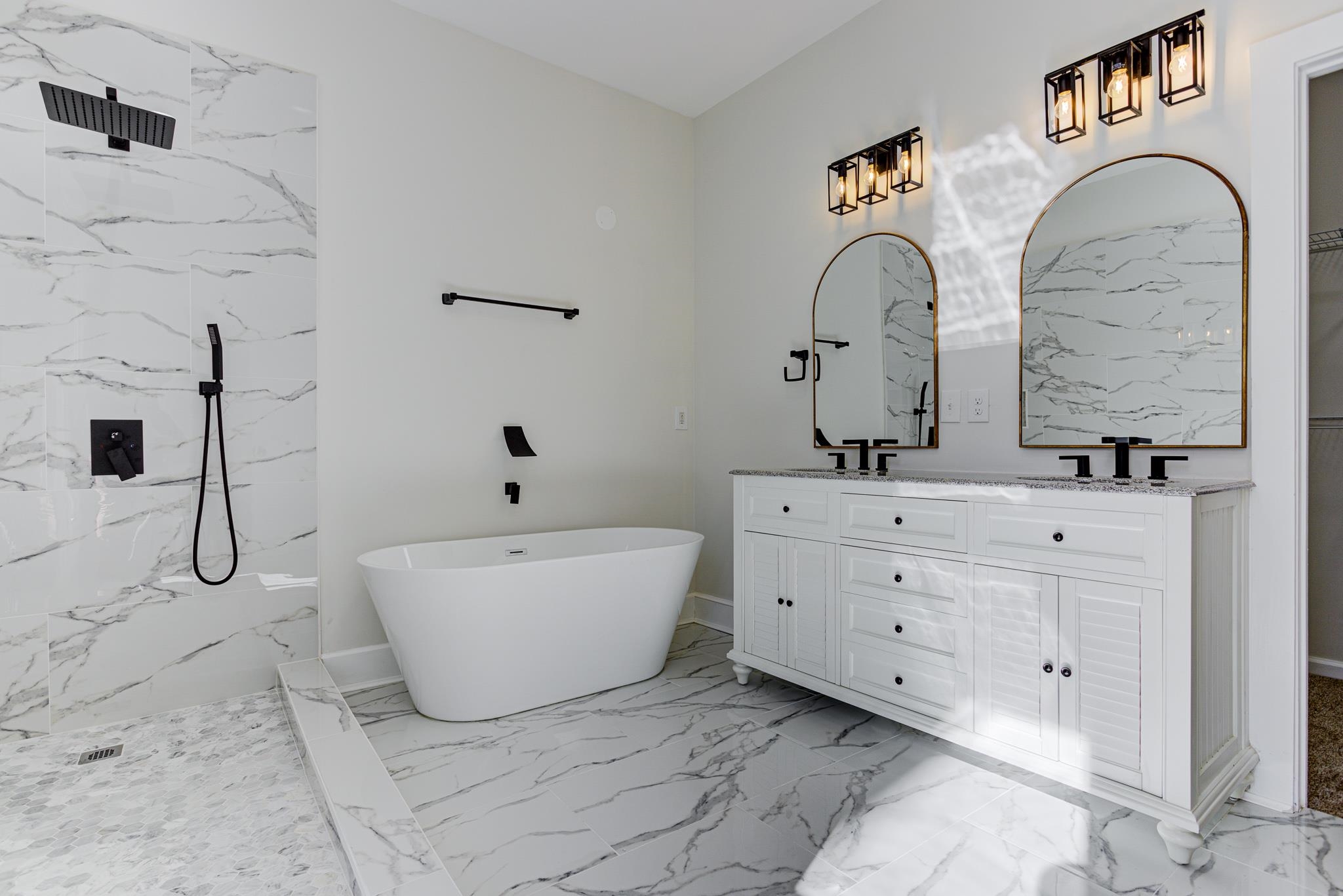 843 South Main Street Covington, TN 38019 - Photo 4 of 25 a bathroom with a double vanity sink bathtub and mirror