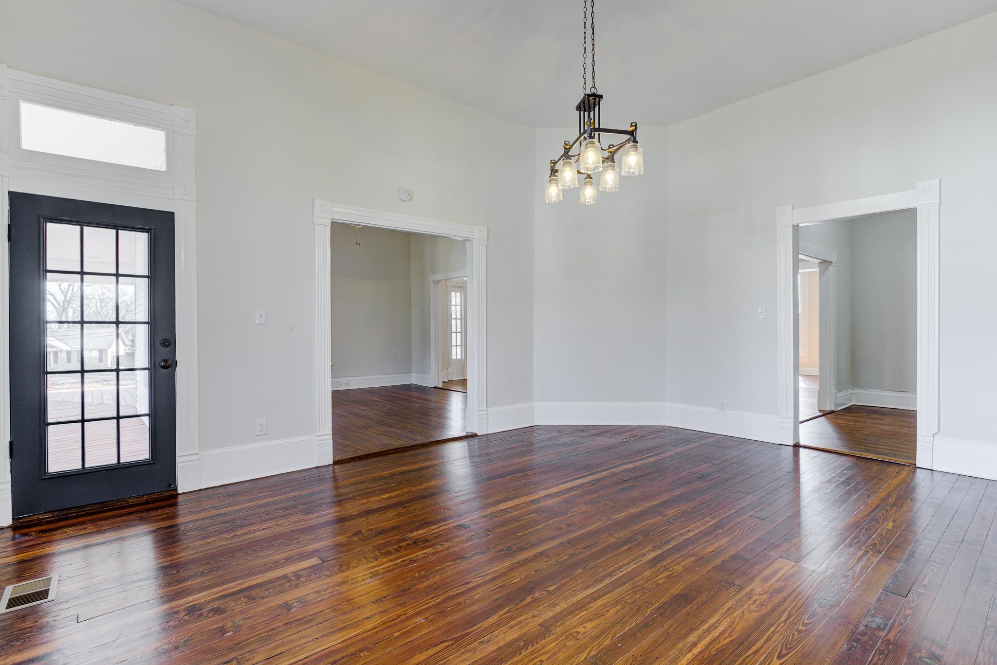 843 South Main Street Covington, TN 38019 - Photo 8 of 25 an empty room with wooden floor chandelier and windows