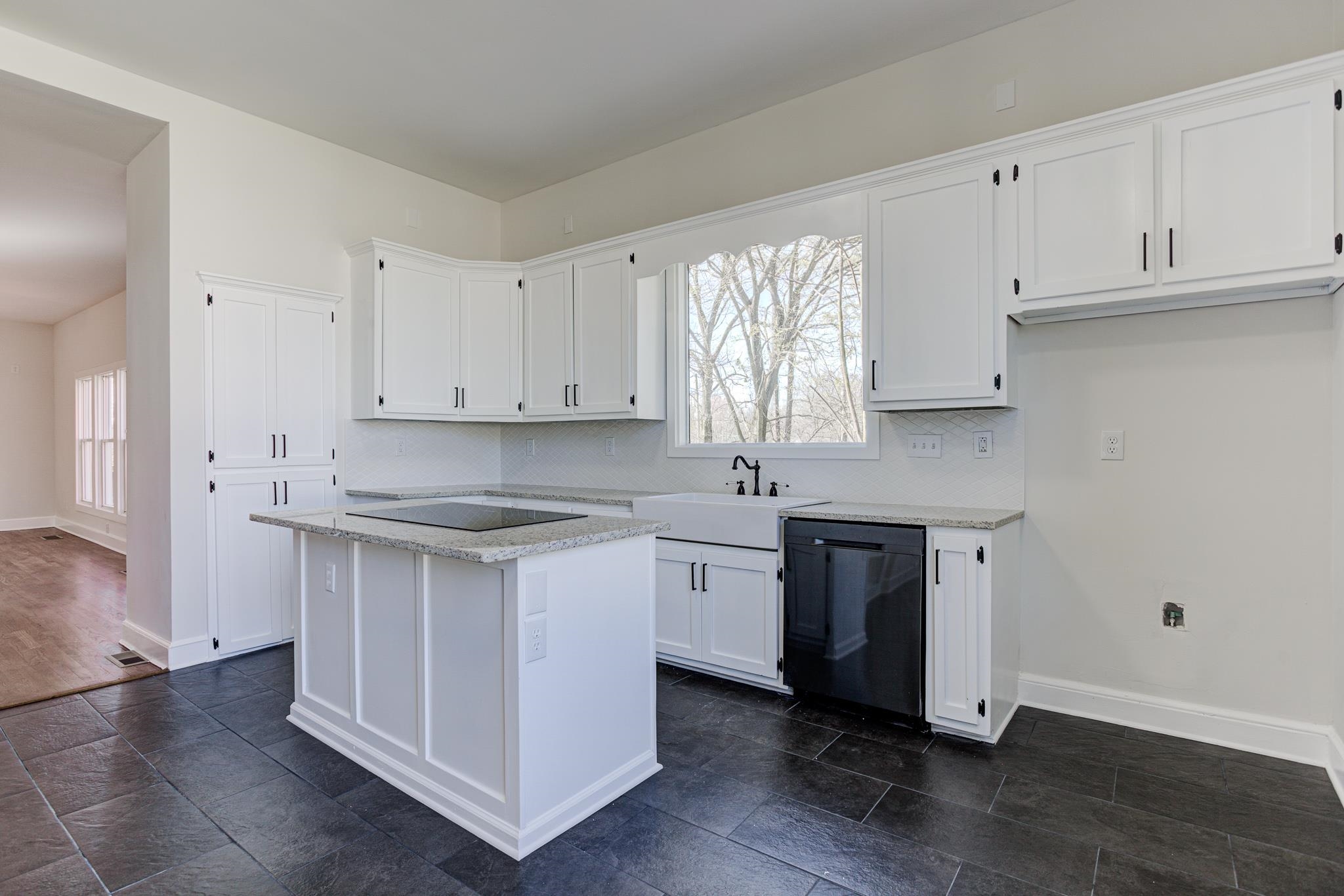 843 South Main Street Covington, TN 38019 - Photo 9 of 25 a kitchen with stainless steel appliances granite countertop a sink stove and white cabinets