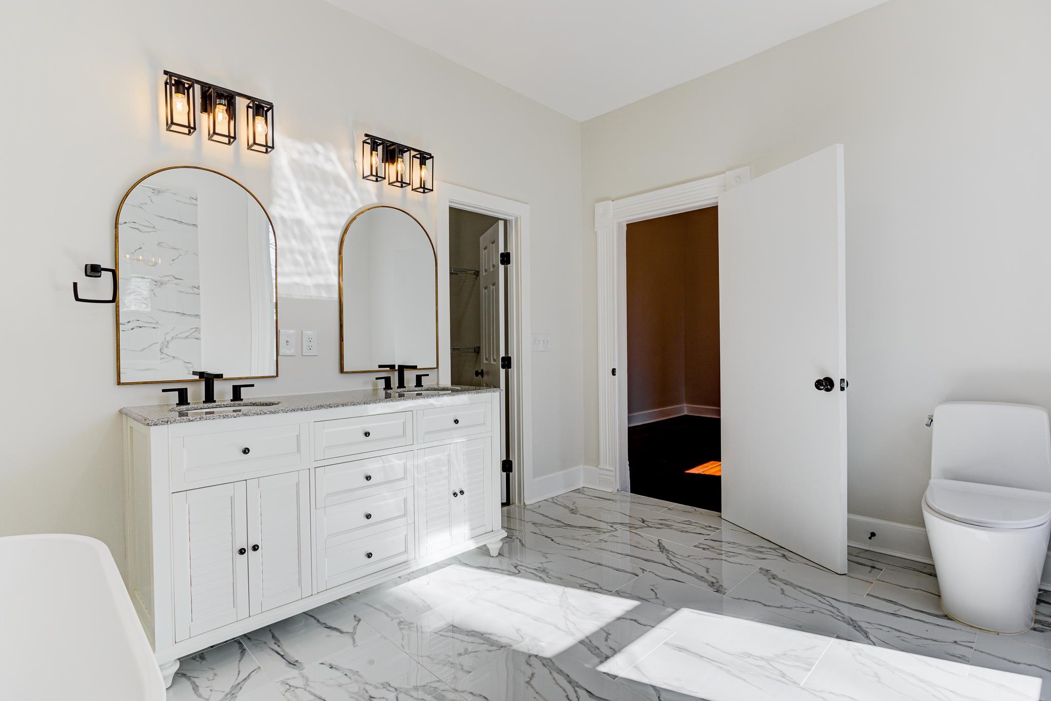 843 South Main Street Covington, TN 38019 - Photo 10 of 25 a spacious bathroom with 2 sink toilet and a mirror