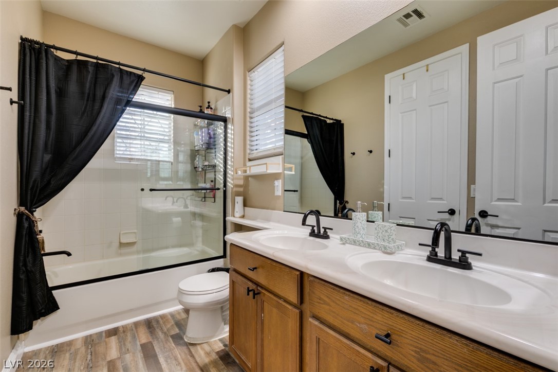7524 Midnight Rambler Street Las Vegas, NV 89149 - Photo 34 of 51 Double vanity sinks and a shower-tub combination provide convenience in this functional bathroom.