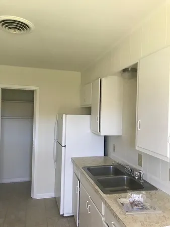 a kitchen with a sink and cabinets