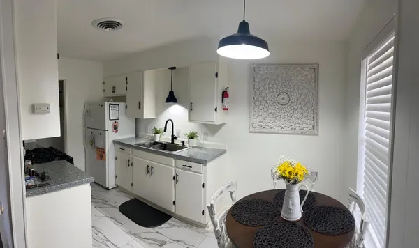 a kitchen with a sink a stove and a refrigerator
