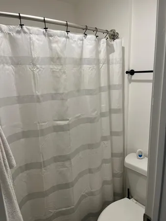 a bathroom with a toilet and shower