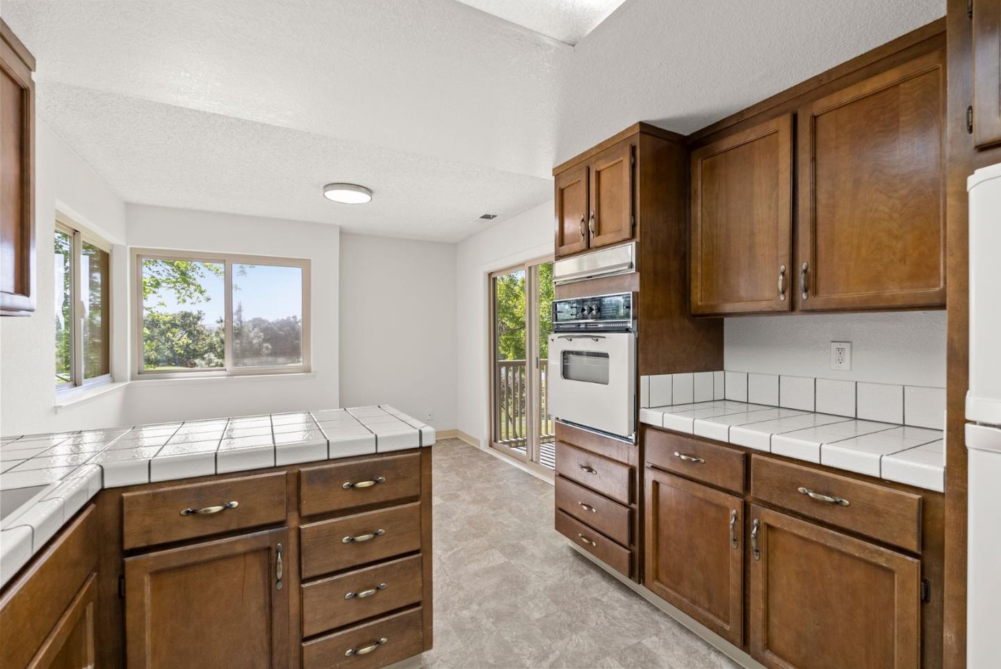 8356 Charbono Court San Jose, CA 95135 - Photo 11 of 48 a kitchen with granite countertop cabinets and window