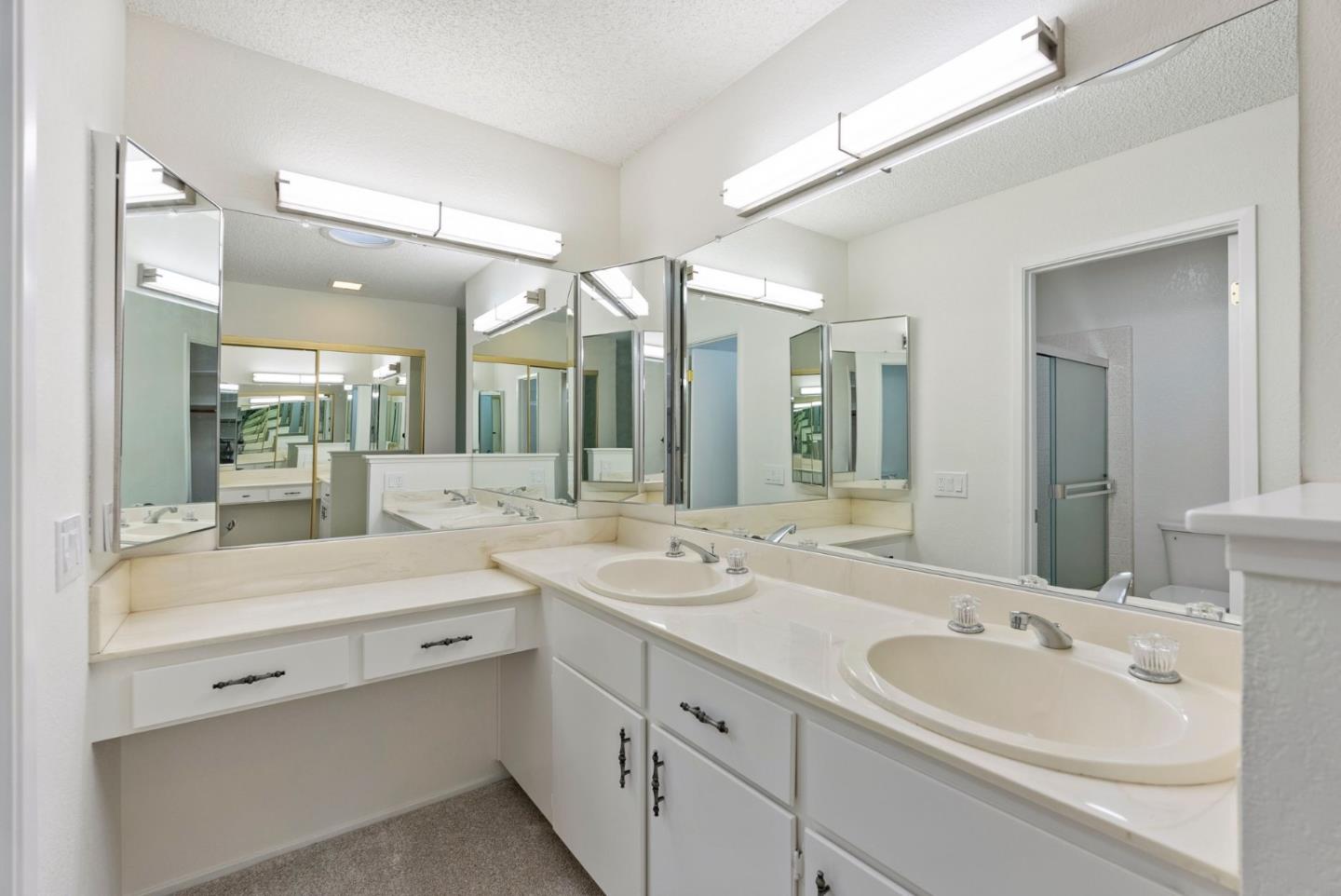 8356 Charbono Court San Jose, CA 95135 - Photo 28 of 48 a bathroom with a double vanity sink mirror and