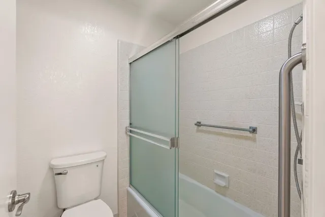a view of a bathroom with a glass door and a window