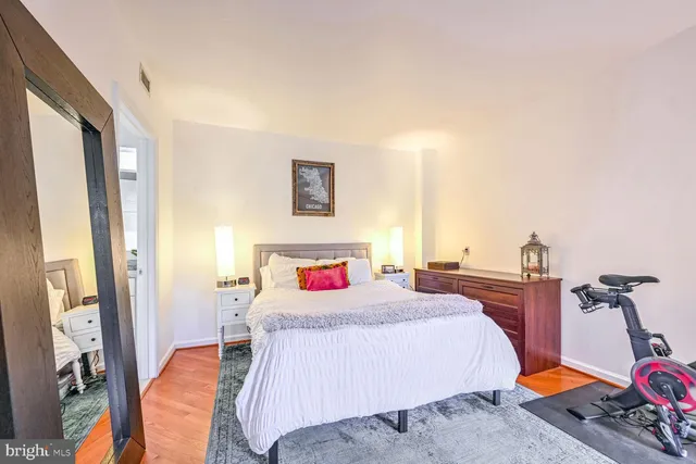 a bedroom with a bed and a night stand