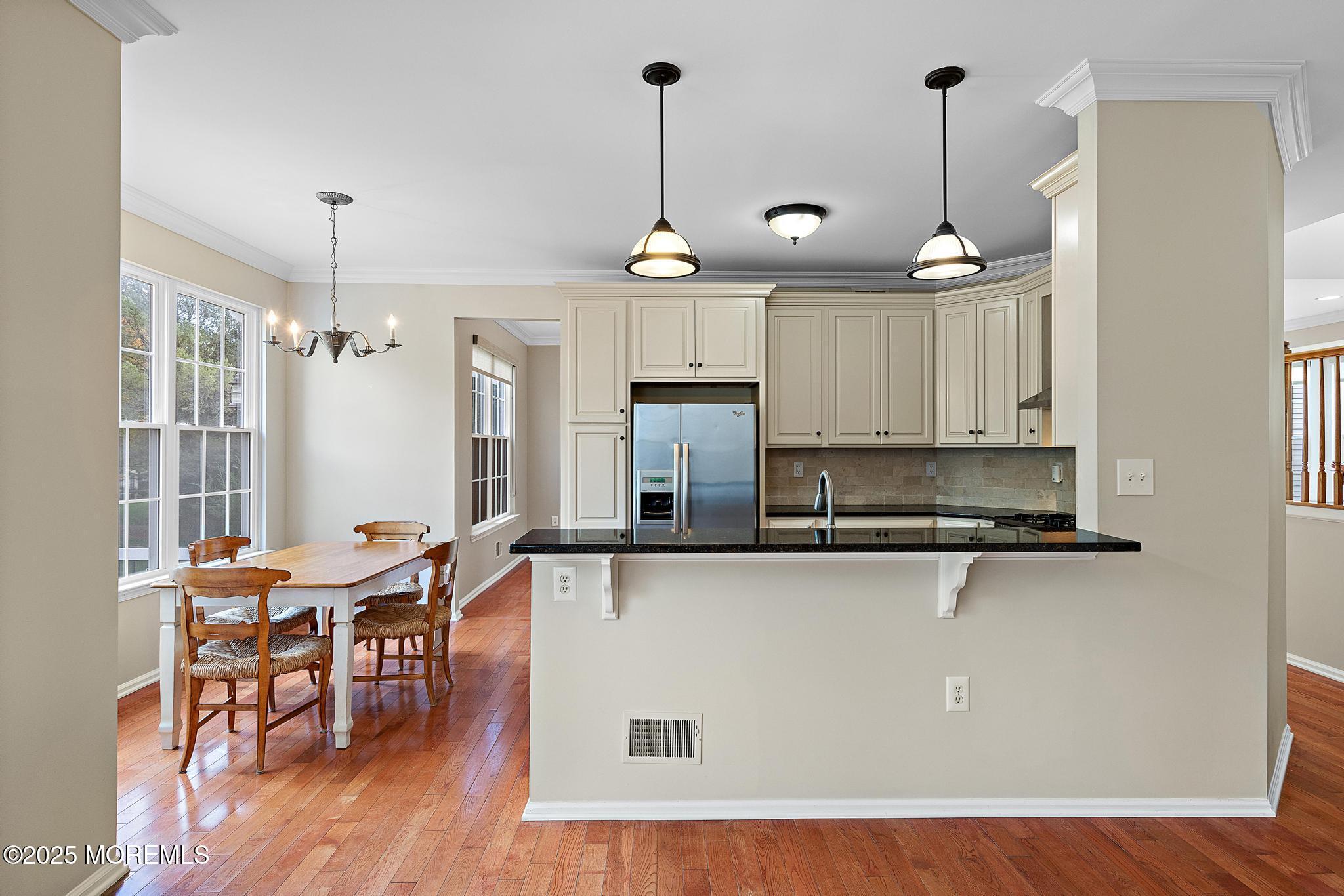 6 Lafayette Colts Neck Colts Neck, NJ 07722 - Photo 11 of 43 a kitchen with stainless steel appliances granite countertop a refrigerator a sink dishwasher a dining table and chairs with wooden floor