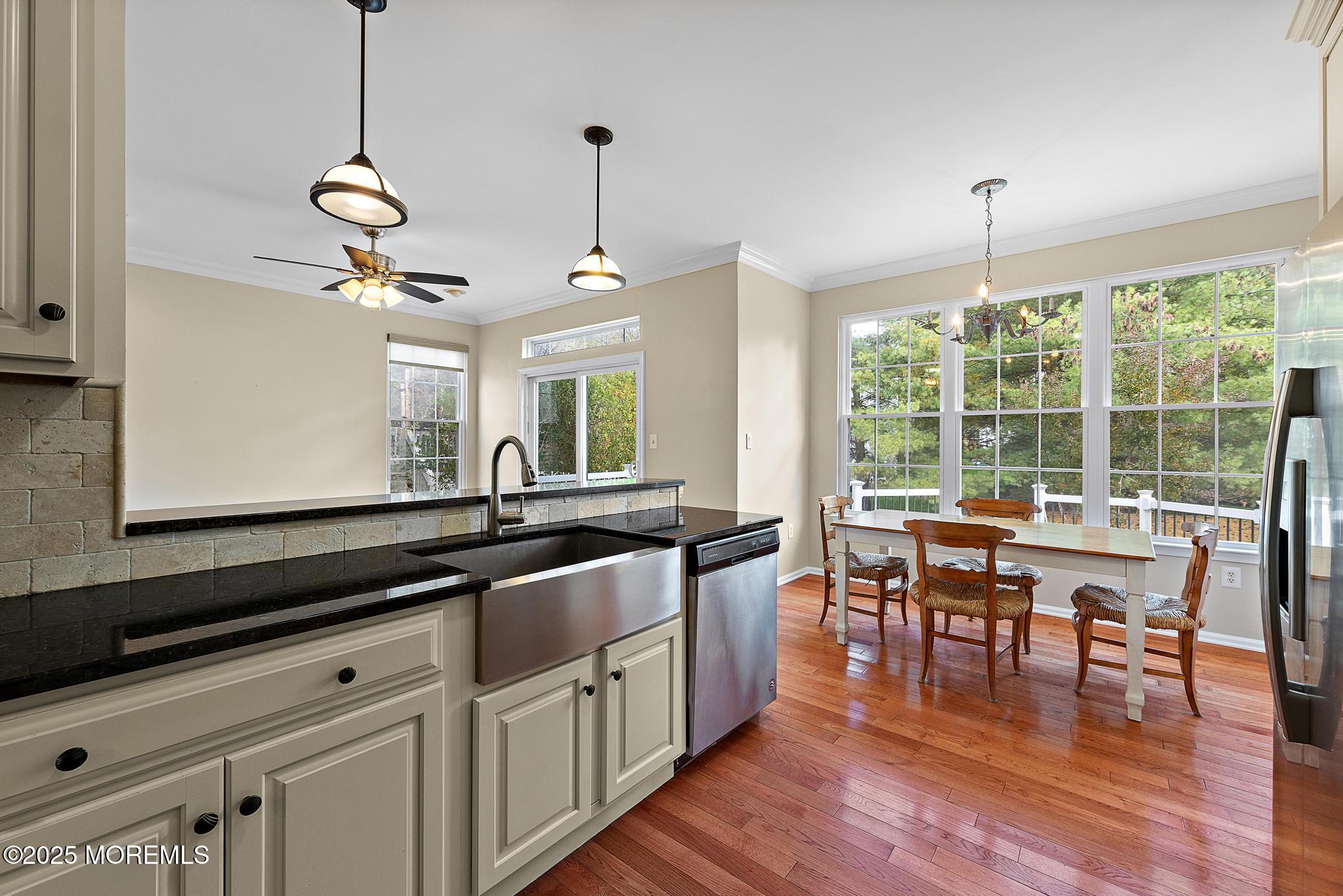 6 Lafayette Colts Neck Colts Neck, NJ 07722 - Photo 13 of 43 a kitchen with stainless steel appliances granite countertop a stove a sink a dining table chairs and wooden floor