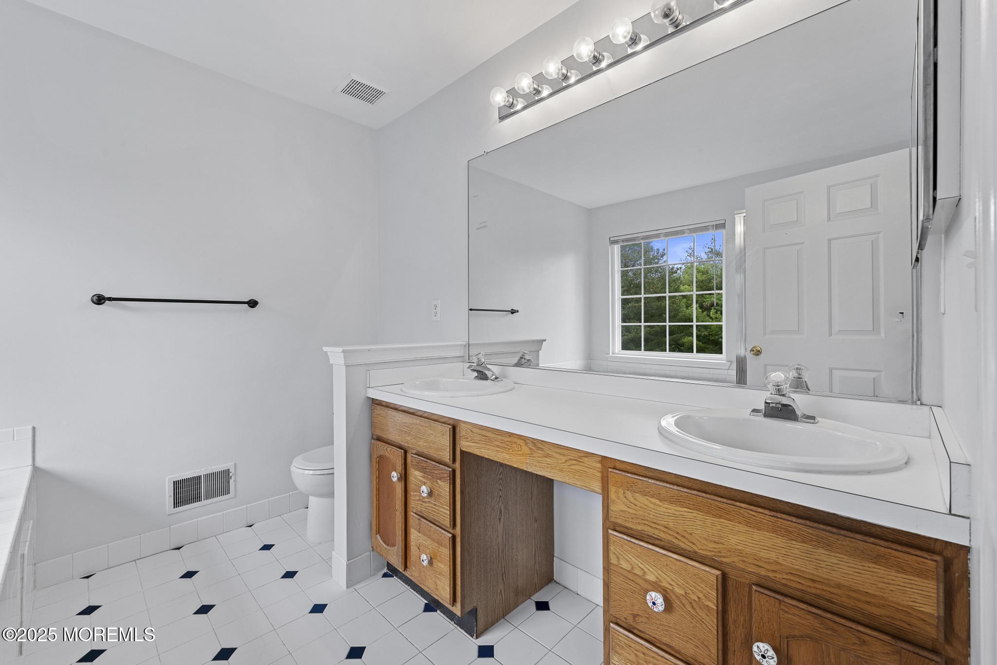 6 Lafayette Colts Neck Colts Neck, NJ 07722 - Photo 22 of 43 a bathroom with a sink double vanity and a mirror