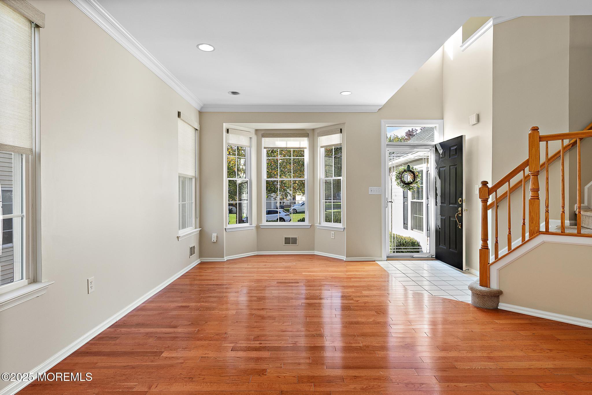 6 Lafayette Colts Neck Colts Neck, NJ 07722 - Photo 5 of 43 a view of an empty room with wooden floor and a window
