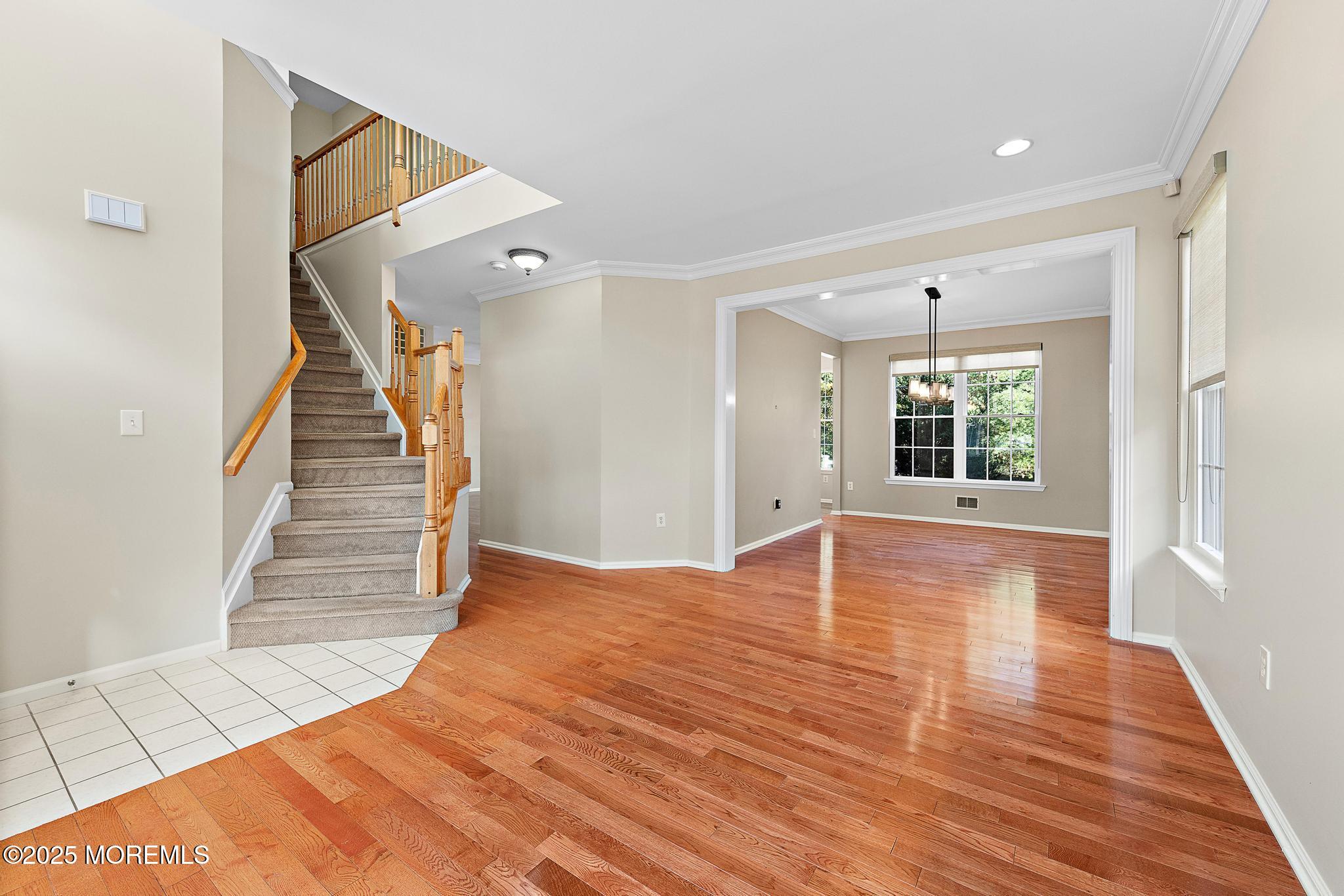 6 Lafayette Colts Neck Colts Neck, NJ 07722 - Photo 6 of 43 a view of empty room with wooden floor and fan
