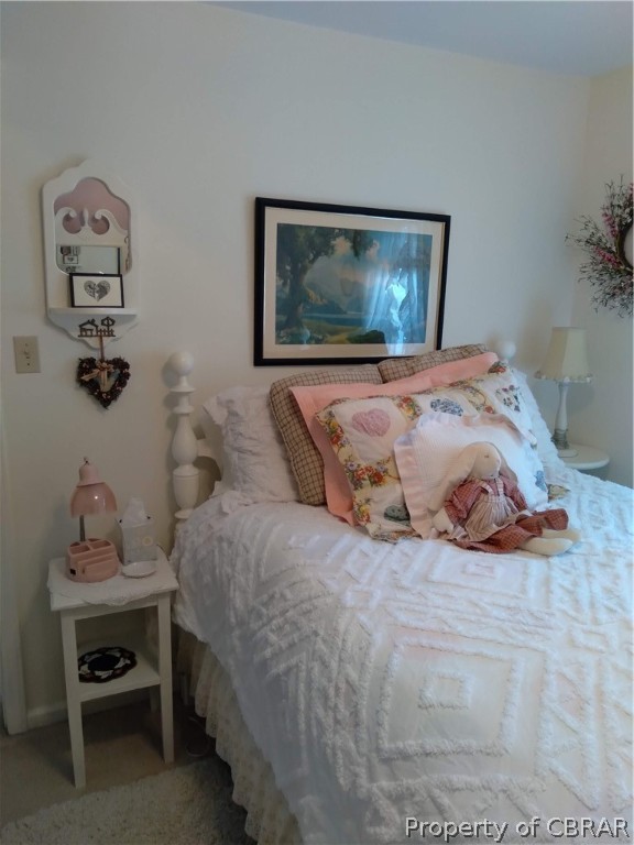 175 Seaside Way Gwynn, VA 23076 - Photo 18 of 48 a bedroom with a bed and a lamp on dresser