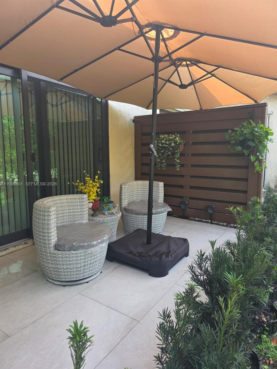 893 Southwest 120th Way Davie, FL 33325 - Photo 22 of 22 a view of a patio with a chairs in patio