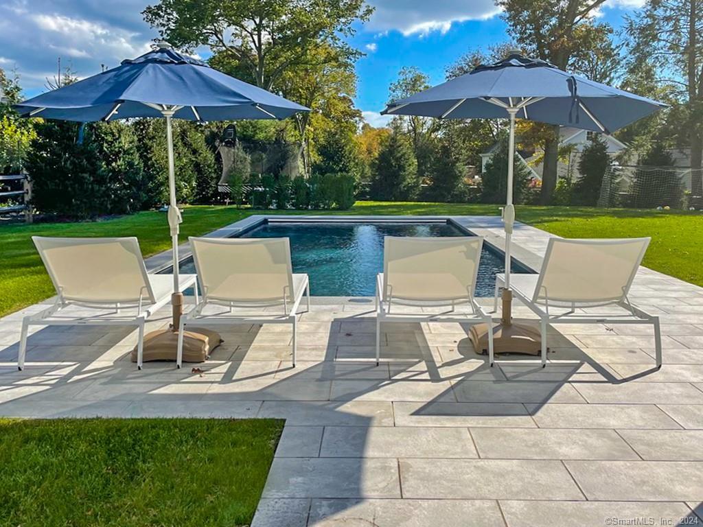 a view of an outdoor sitting area with couch and umbrella