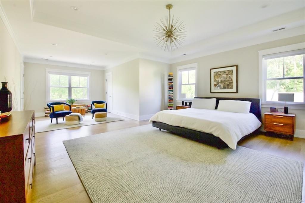 17 Stony Brook Road Westport, CT 06880 - Photo 22 of 39 a spacious bedroom with a large bed and a chandelier